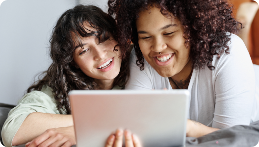 A couple is giving feedback on a laptop